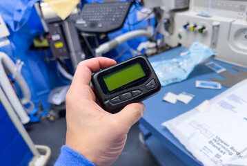 vintage pager on a busy desk, symbolizing hectic work life and essential communication in a...