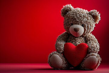 a cute Valentine teddy bear holding a romantic red love heart against a red background