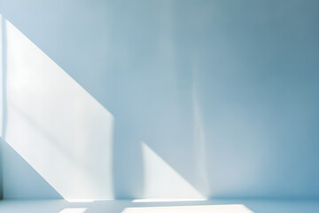 Minimal abstract light blue background for product presentation. Shadow and light from windows on plaster wall