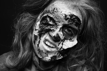 Scary zombie on dark background, black and white effect. Halloween monster