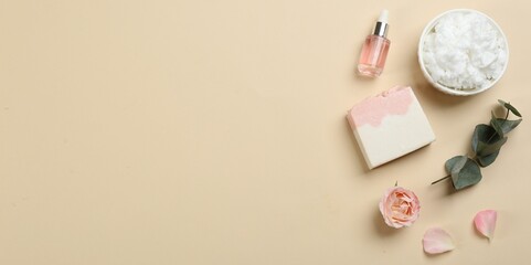 Flat lay composition with natural handmade soap and ingredients on beige background. Space for text