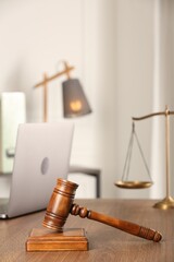 Law concept. Gavel, scales and laptop on wooden table in office