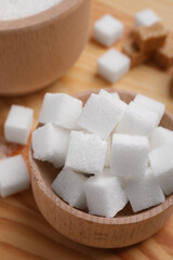 White sugar cubes in bowl on table, above view