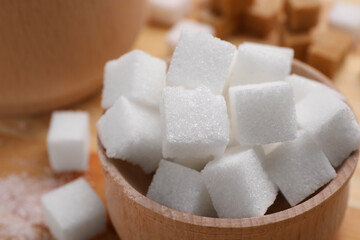 White sugar cubes in bowl on table, closeup