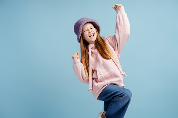 Smiling attractive girl wearing stylish casual clothes posing, looking at camera dancing