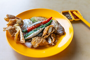 Yong tofu with chee cheong fun combination served in plate with sauces, popular street food in...
