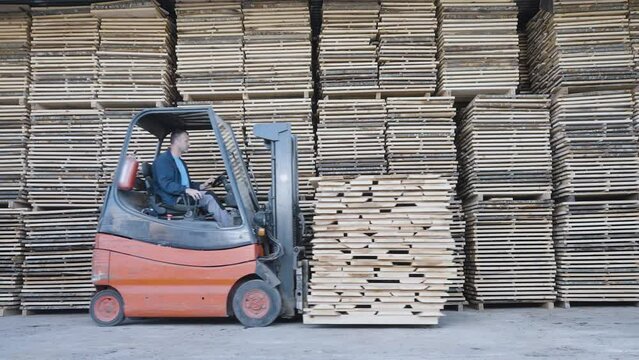 Forklift driver working in industrial factory or warehouse