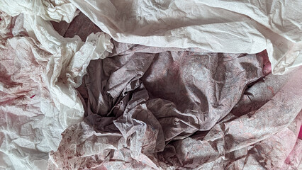 Crumpled tissue paper with a delicate pink hue