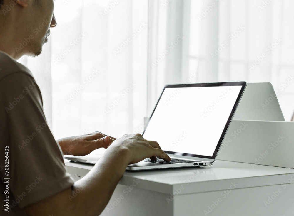 Canvas Prints man's hands using laptop with blank screen on white table at home or office.