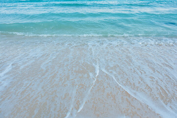 Soft wave of blue ocean on sandy beach. Summer vacation in island. clear azure water Background.