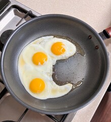 fried eggs in a frying pan