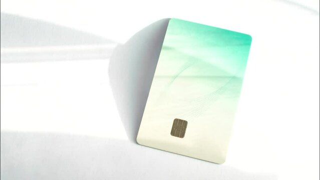 Credit card on a white surface, highlighting simplicity and elegance in financial transactions. Credit card on a white surface, emphasizing simplicity and versatility in transactions.