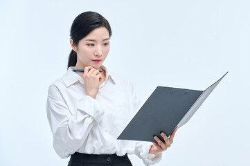 A beautiful Asian woman is making various facial expressions and gestures while holding a document file and a ballpoint pen for business.