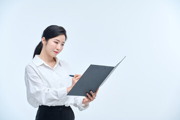 A beautiful Asian woman is making various facial expressions and gestures while holding a document file and a ballpoint pen for business.