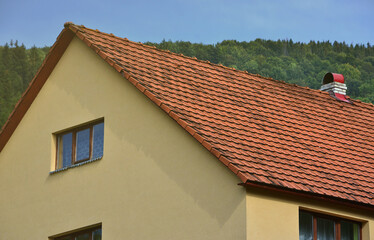 The roof of this square ceramic tile is red. The old type of roof covering in rich houses of the 19th century