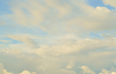 A blue cloudy sky with many small clouds blocking the sun