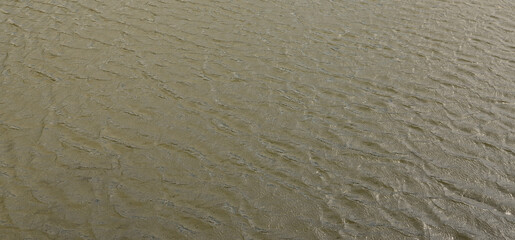 The texture of dark river water under the influence of wind, imprinted in perspective. Horizontal image