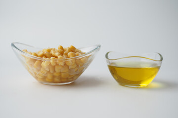 Corn oil with fresh corn on table 