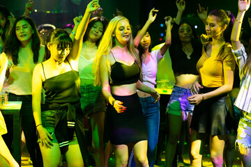 Happy fun people drinking in night club. diverse young people dancing in night club. Nightlife and disco dance party concept. Fun music festival