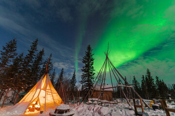 Aurora Borealis, Northern Lights, over aboriginal tent teepee at Yellowknife, Northwest...