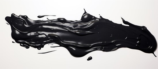 Black wet paint on a white surface.