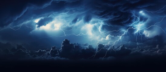 Nighttime storm with electric lightning inside dark blue clouds
