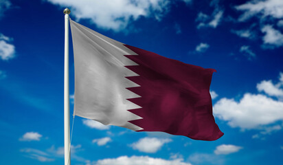 Qatar Flag on the flag pole waving beautifully in the sky