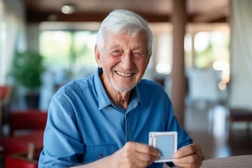 Foto op Plexiglas Happy senior man playing card games with friends, activity social networking in nurs home. Concept enjoying playtime together in poker game, old men © Adin