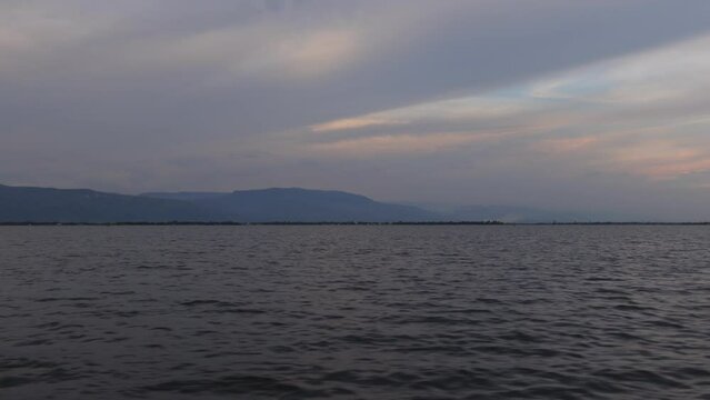 A view of the marsh water from a moving boat. Scenery of wetland water in Haor, Sunamganj, Bangladesh.