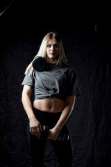 Portrait of a young beautiful girl working out in the gym.