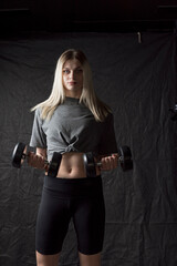 Portrait of a young beautiful girl working out in the gym.