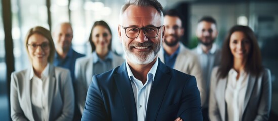 Obraz premium Confident business team, leader at forefront, looking at camera, smiles.