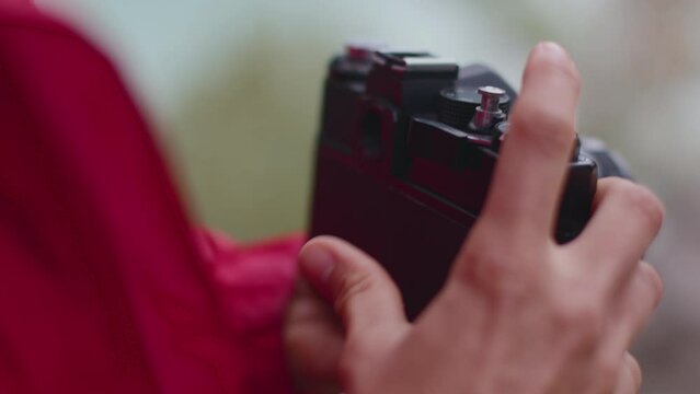 retro camera. the girl changes the film in the camera. the photographer sets up the camera before shooting.