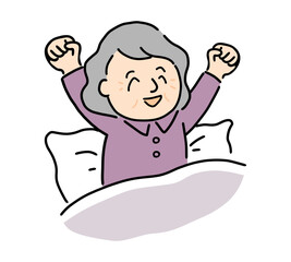 スッキリと目覚めて伸びをするシニア女性