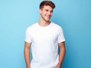 smiling young man in white shirt against blue background