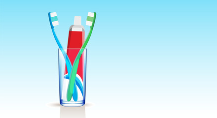 Set of blue and green toothbrushes and multi-colored toothpaste in a medical tube in a glass beaker on a blue gradient background. Copy space.