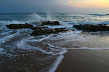 Obraz premium Sea at sunset with waves on the beach. Greece - the island of Corfu.