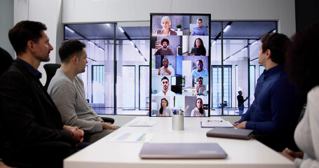 Businesspeople Sitting In A Conference Room Looking - obrazy, fototapety, plakaty