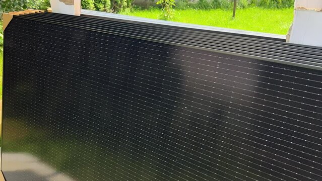 Close-up new solar panels with protective cardboard corners, ready for installation. Renewable energy technology, green living, and the implementation of solar power in residential areas.