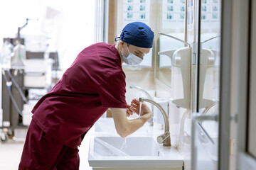 male surgeon washes his hands before surgery, doctor's sterile hands