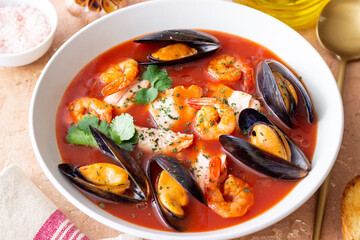 Bouillabaisse soup with fish, mussels and shrimps. French cuisine. Seafood.