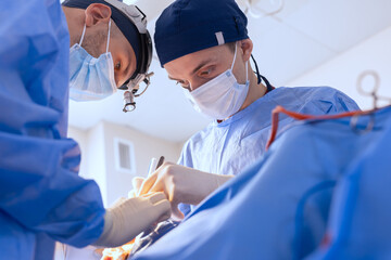 male surgeons perform surgery in operating room, plastic surgeon in operating room - obrazy, fototapety, plakaty