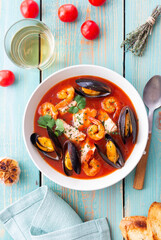 Bouillabaisse soup with fish, mussels and shrimps. French cuisine. Seafood.
