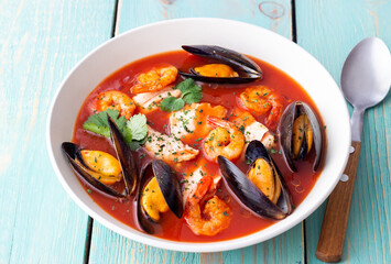 Bouillabaisse soup with fish, mussels and shrimps. French cuisine. Seafood.