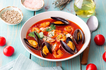 Bouillabaisse soup with fish, mussels and shrimps. French cuisine. Seafood.