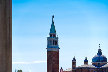 Old town of Venice with skyline and Basilica di San Giorgio Maggiore church in the background on a sunny summer day. Photo taken August 7th, 2023, Venice, Italy.