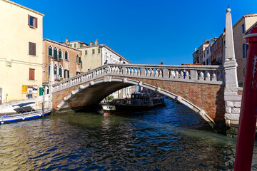Scenic view of Guglie Bridge with skyline of the old town of Italian City of Venice on a sunny summer morning. Photo taken August 7th, 2023, Venice, Italy.
