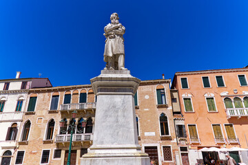 Fototapeta na wymiar Old town of Italian City of Venice with square named Santo Stefano and statue of Nicolo Tommaseo on a sunny summer day. Photo taken August 7th, 2023, Venice, Italy.