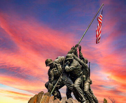 Washington D.C., USA; June 2, 2023: The Marine Corps Battle of Iwo Jima war memorial carrying the American flag, at the dawn of a new day.