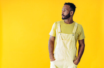 Man posing on colored backgrounds in studio wearing trendy clothes